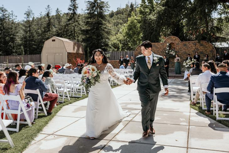 Bride and groom walking down the aisle after outdoor ceremony at Gather Events Ukiah wedding venue